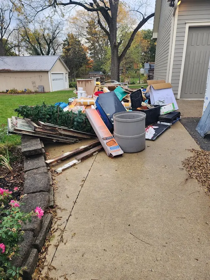 Dumpster being loaded with debris for Commercial Dumpster Rental in Polk